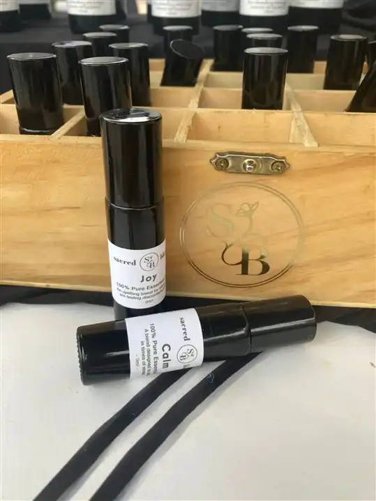Calm and Joy roll-on combo from Sacred Blends, featuring two black roll-on bottles with labels.