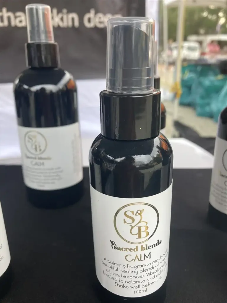 Sacred Blends CAM calming fragrance spray in a black bottle with a clear pump top.